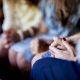 closeup-shot-of-females-sitting-while-holding-hands-and-praying