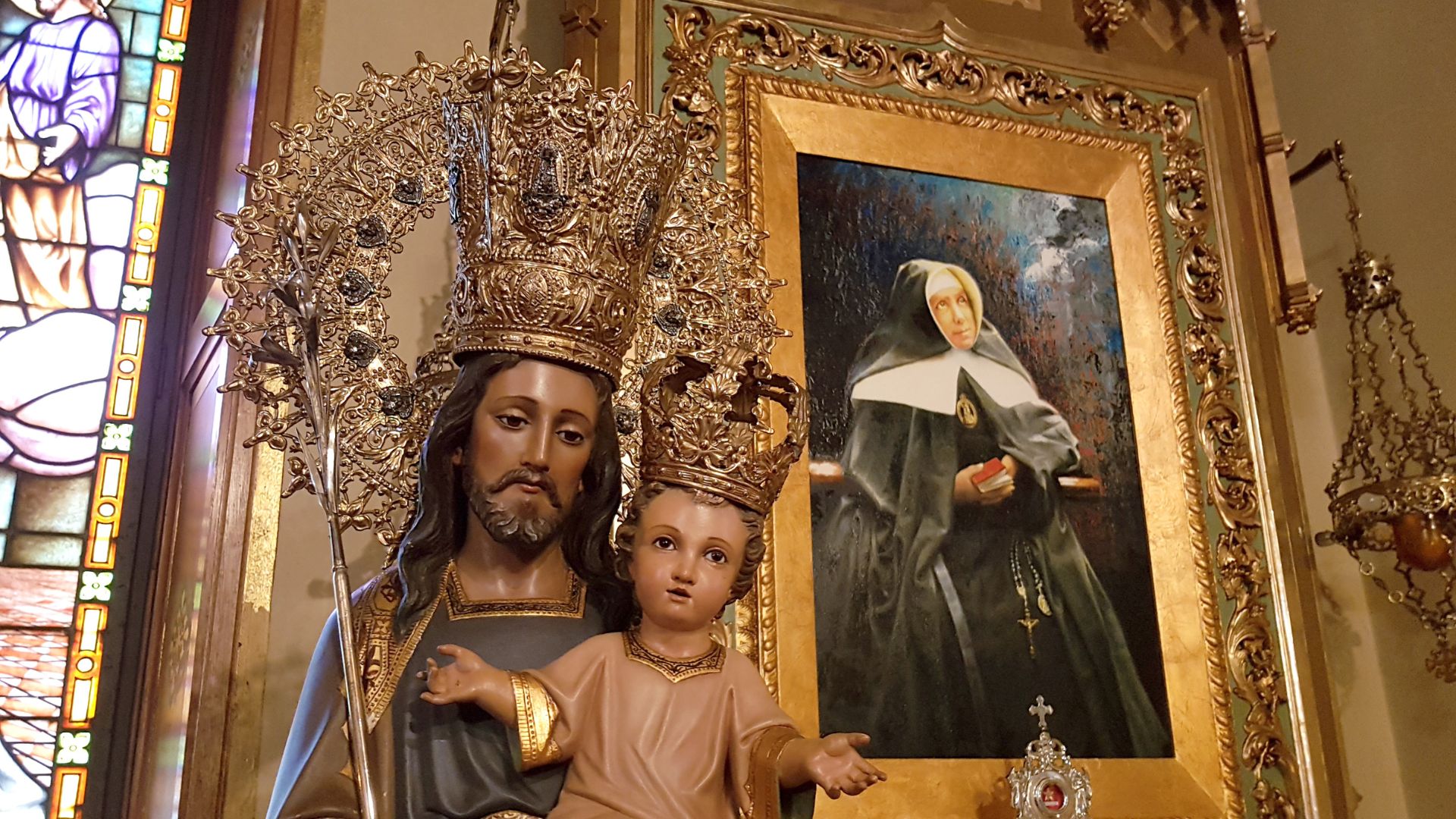 Figure of Saint Joseph of the Mountain next to a portrait of Mother Petra in the sanctuary's oratory."